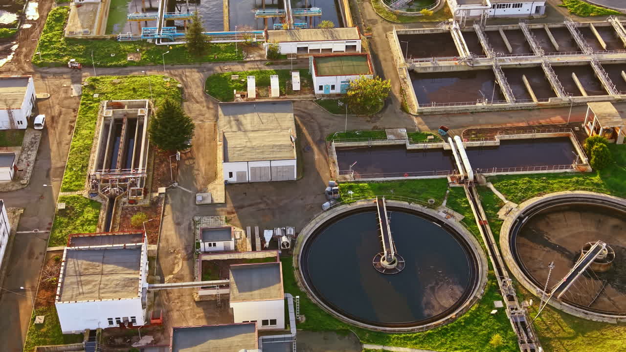 Water treatment facility in a serene landscape showcasing modern technology and nature's balance with clear blue skies on a sunny day
