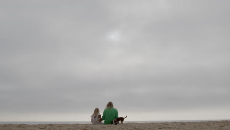 family enjoying a cloudy day at the beach