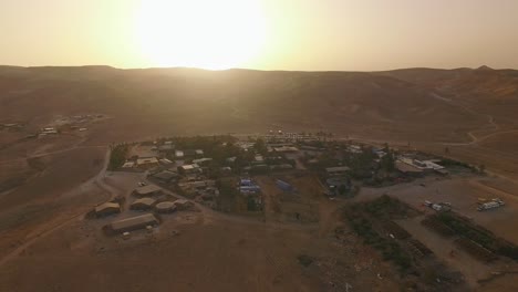 Aerial-drone-shot-around-green-Village-in-the-Yellow-Desert