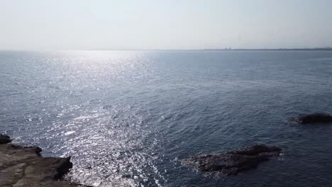 sunny day on a rocky coastline with ocean views and people