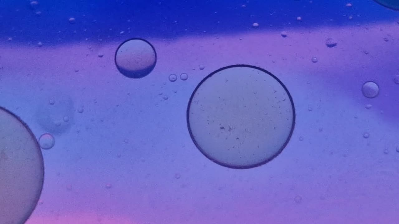 Macro shot of oil and soap bubbles creating an abstract and colorful psychedelic background