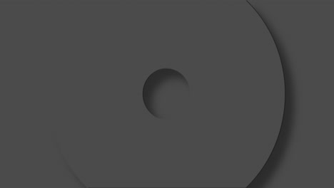 animation of grey circles and crosses spinning on grey background