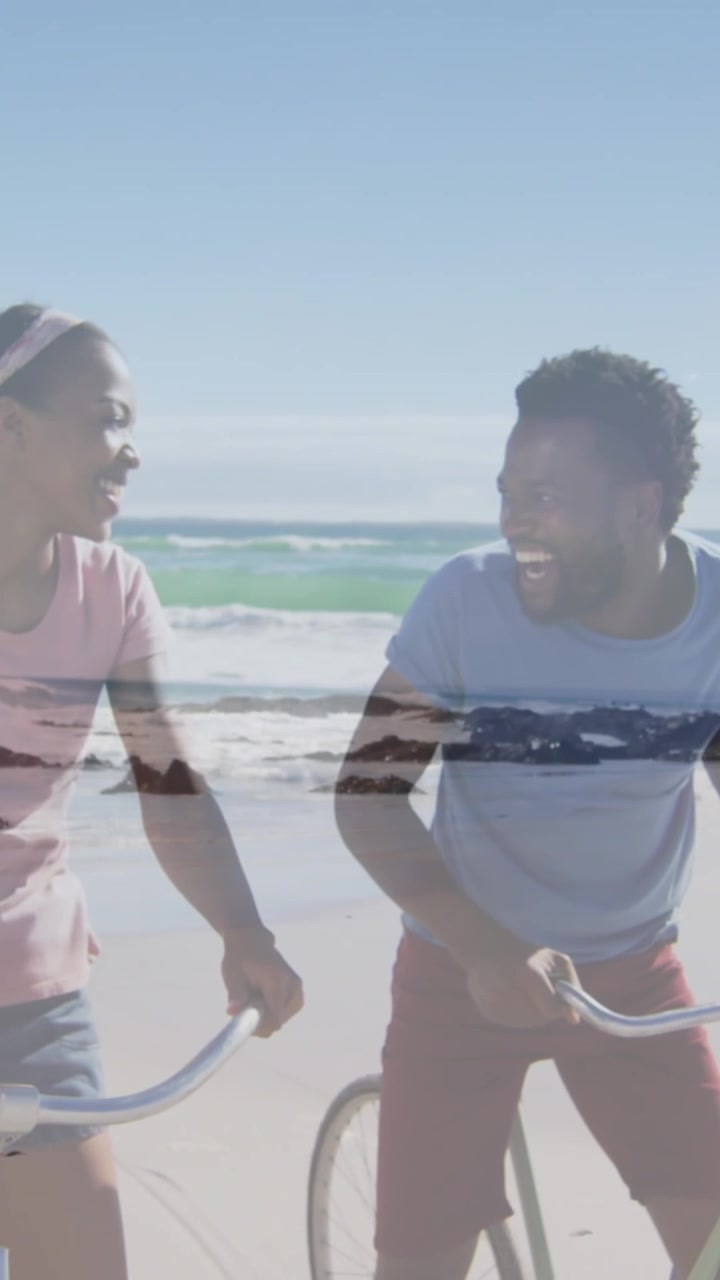 Animation of happy african american couple with bikes over seascape