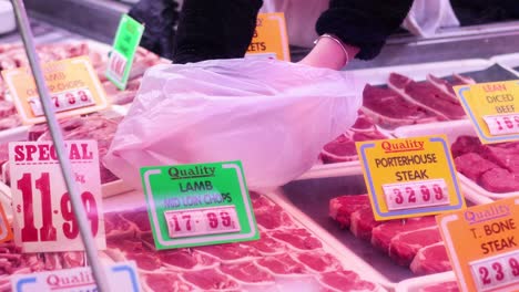 customer selecting meat from market display