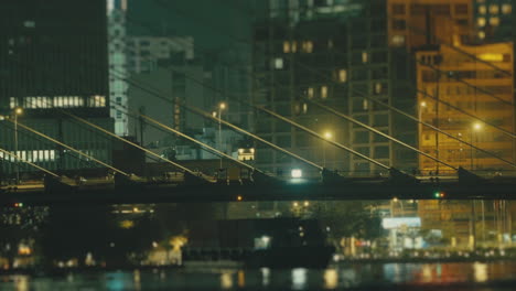 a view of cable-stayed suspension bridge over night cityscape