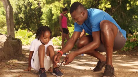 Father-is-doing-his-son-shoelaces-