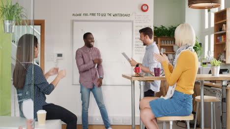 Crazy-happy-african-american-businessman-dancing-doing-victory-dance-in-team-meeting-celebrating-success-achievement