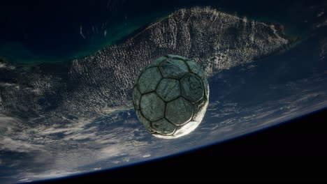 old soccer ball in space on earth orbit