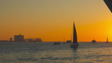boats on the river tagus during sunset, lisbon, portugal