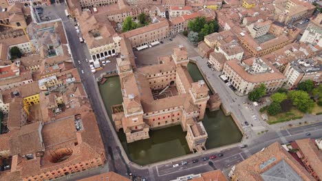 symmetrical red-brick estense castle corner towers in heart of ferrara old town