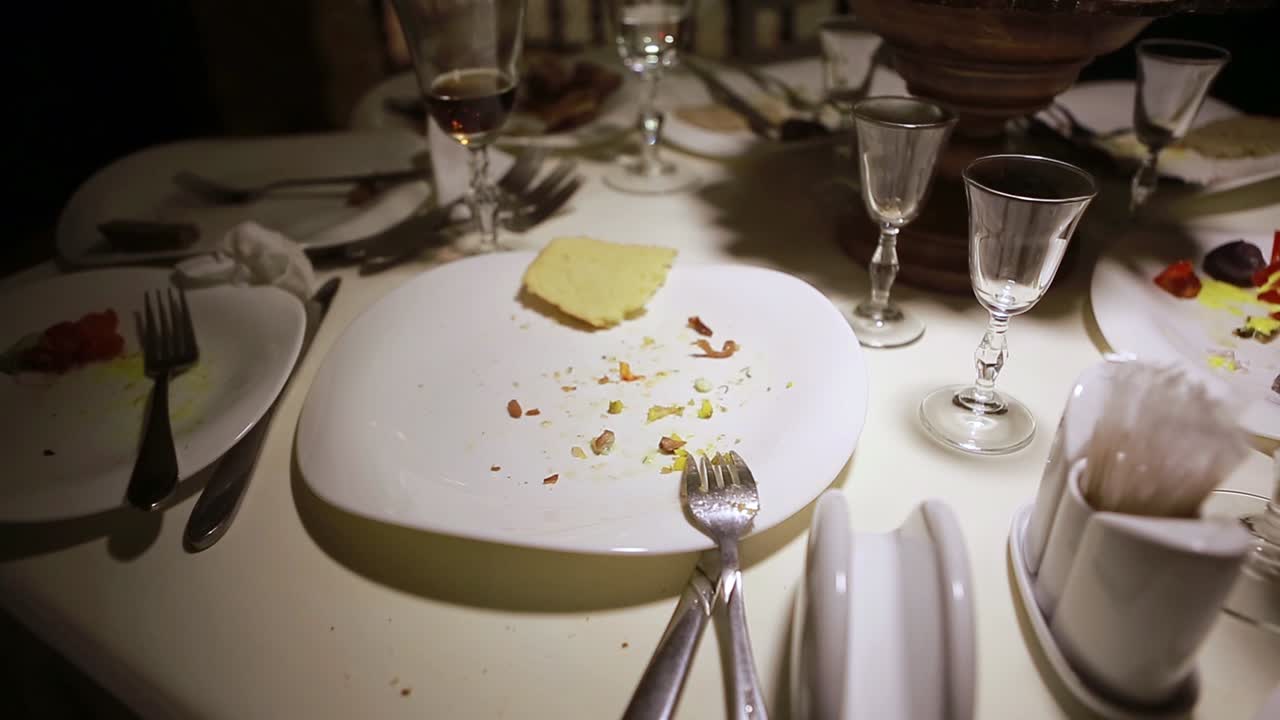 Table After Dinner Party. Dirty dishes scattered on the table