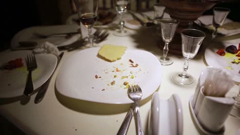 table after dinner party. dirty dishes scattered on the table