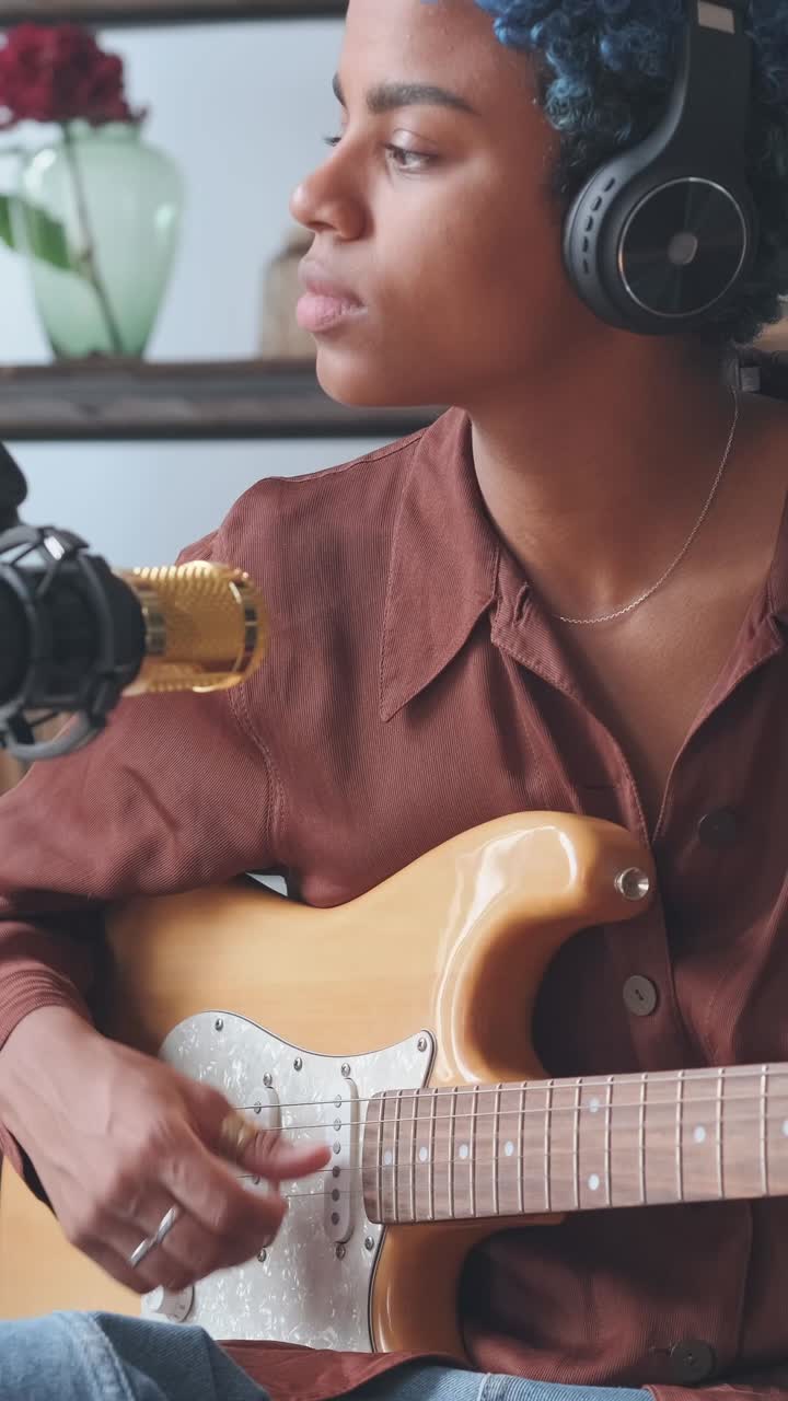 Musician plays guitar while lost in melodies during a creative session