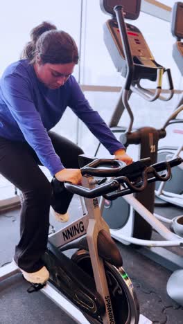 young woman doing spinning exercise at the gym