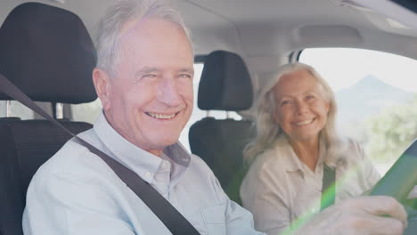 Portrait-Of-Senior-Couple-Sitting-In-And-Driving-Hire-Car-On-Summer-Vacation