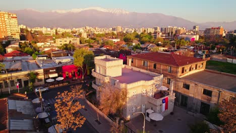 aerial view establishing the sermini castle, current headquarters of the employment department of providencia santiago chile, chilean flag in vertical view