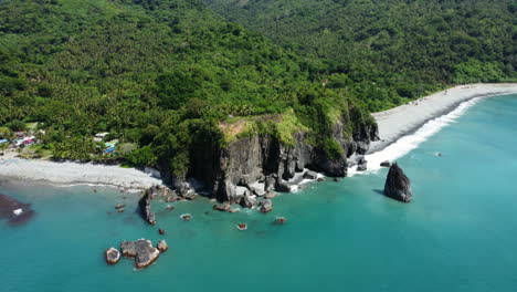 Orbit-Shot-of-Huge-Rock-Formation-at-the-Astonishing-Ampere-Beach,-Dipaculao,-Aurora,-Philippines