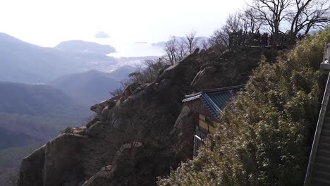 a panning shot of a buddihst temple and a town behind in south korea during winter (shoot info: cin2, 1080p, 23.97fps slowmotion from 59.94fps)