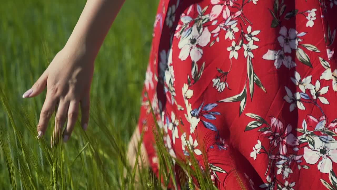 빨간 드레스를 입은 슬로우 모션 큐 소녀가  ⁇ 을 따라  ⁇ 고 스파이클 ⁇ 을 만지며 드레스가 바람에 날아다니고 있습니다.