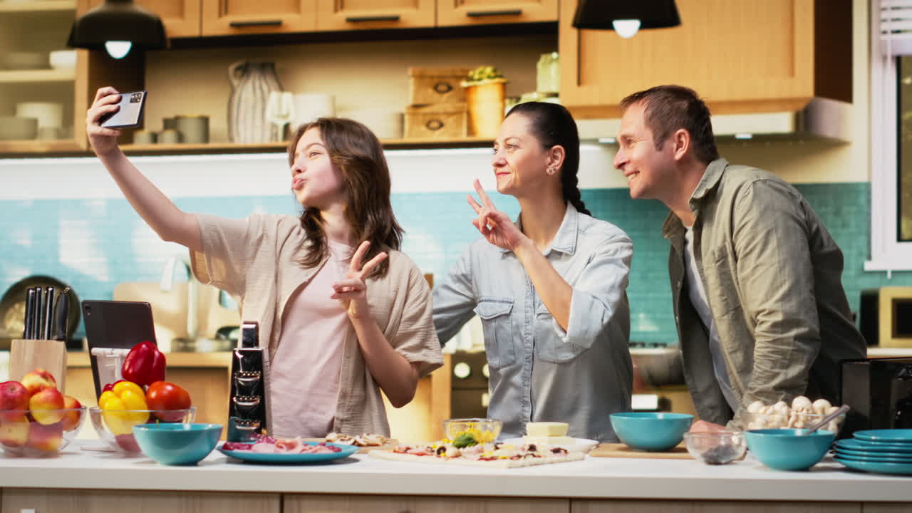 Tween daughter taking a family photo of her and parents during cooking time
