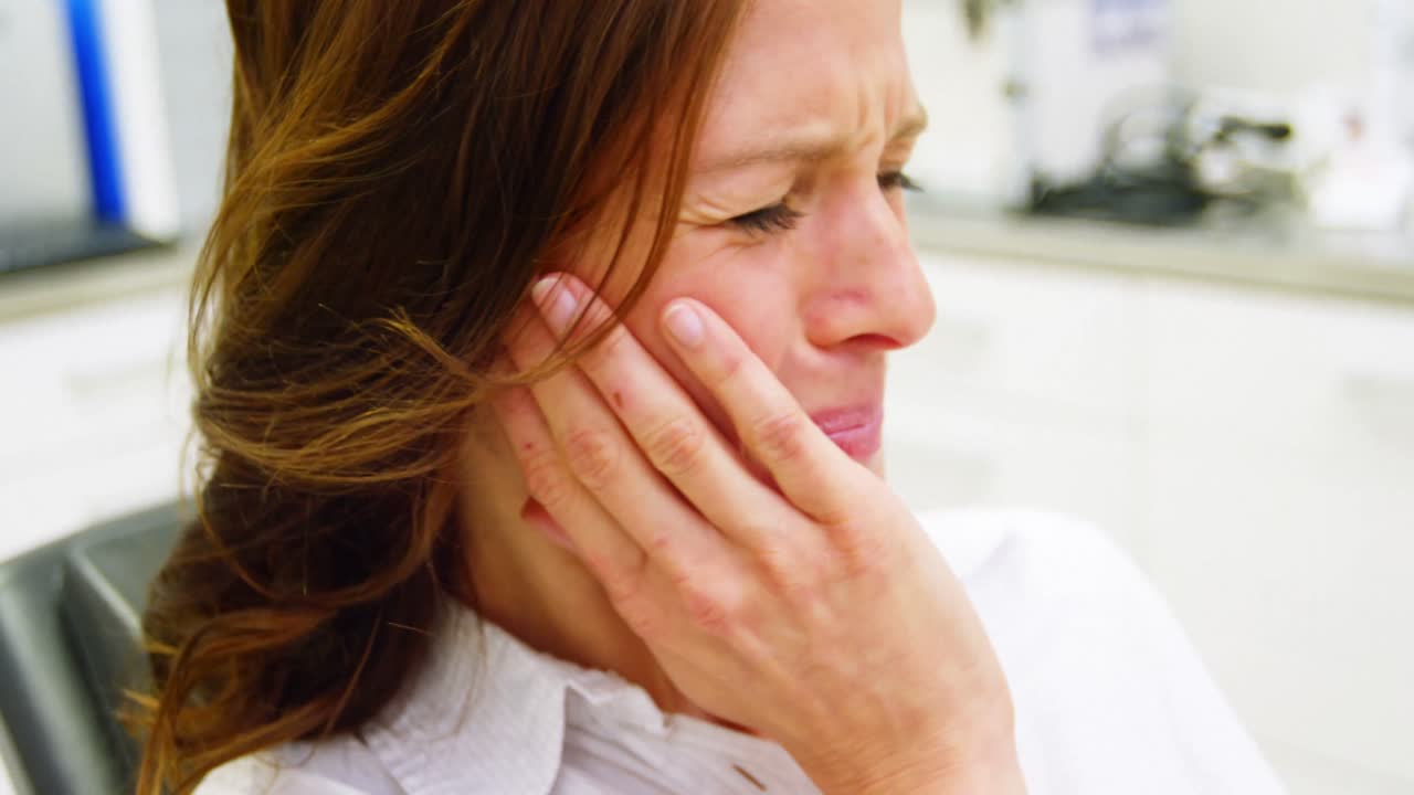 Unhappy female patient having a toothache
