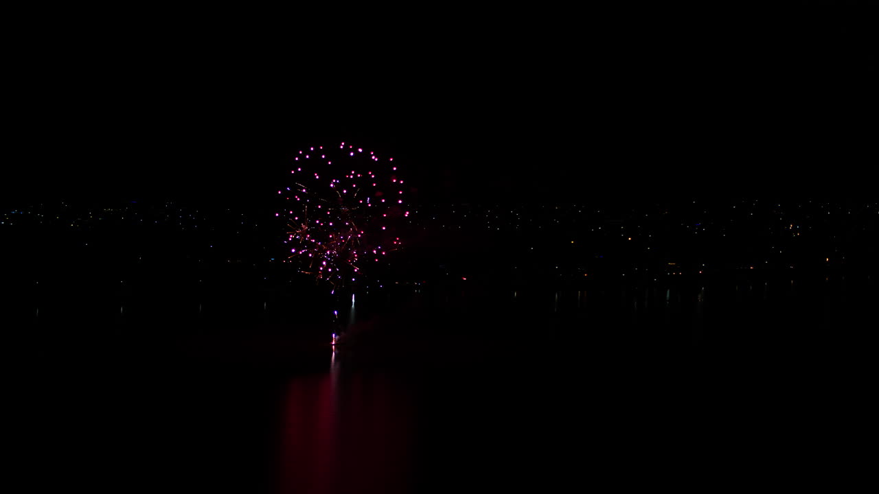 Aerial drone shot of Fireworks display over a large lake in rural Australia