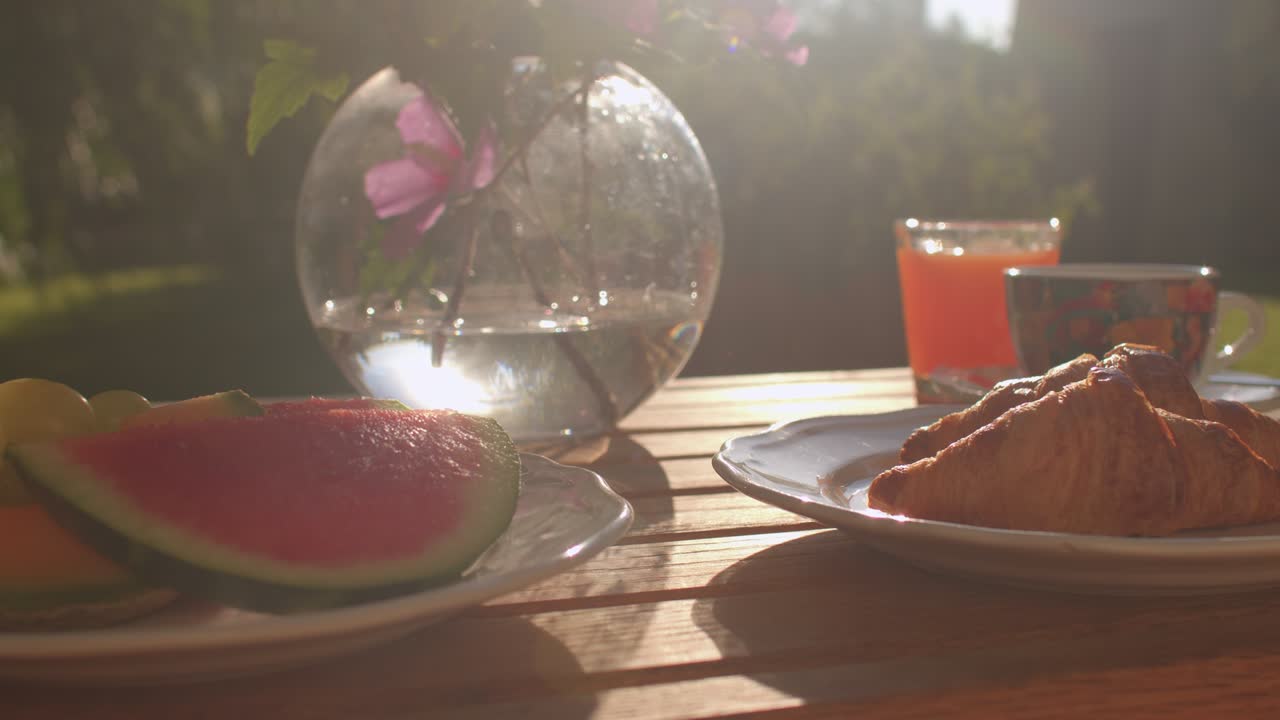 desayuno con luz de fondo en la mesa, croissants, sandía, listo para comer.