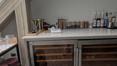 arranging drinks and glasses on a bar counter