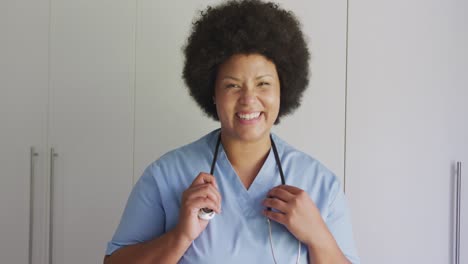 Video-of-happy-plus-size-african-american-female-doctor-looking-at-camera