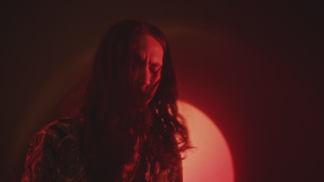 Rock Guitarist Performing in Dark Studio with Red Light