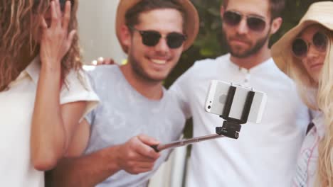 smiling hipster friends taking selfie