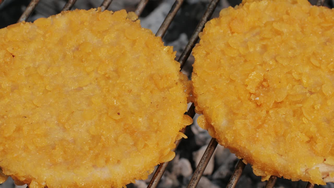 Veggie orange burger on grill, carrot and oats burger with corn and yellow pepper, vegetarian food barbeque, potato grill burger.