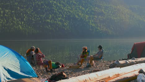 group of friends camping near riverside 4k