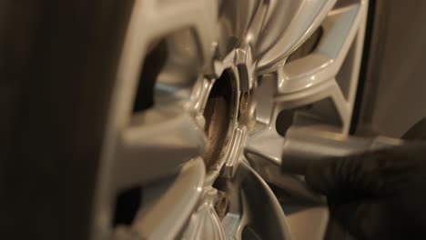 car mechanic replacing a car tire in garage workshop. slow motion. auto service