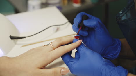 master of nails makes a professional manicure. beautiful female hands. hand care in the spa. close-up