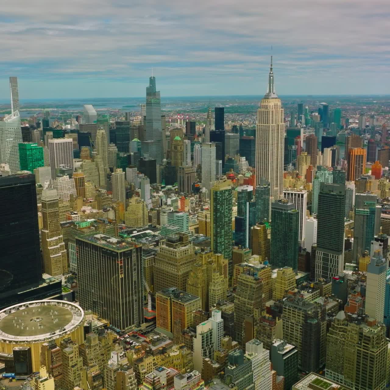Densely built up city with skyscrapers and usual blocks of flats. Huge New York panorama at the blue sky background