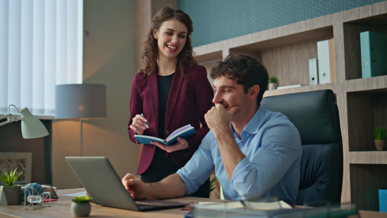 Smiling employees talking workplace. Happy businessman discussing work ideas