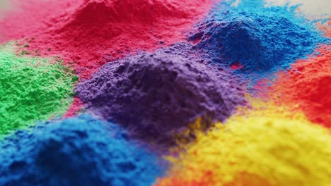 video of close up of multi coloured powders with copy space on white background