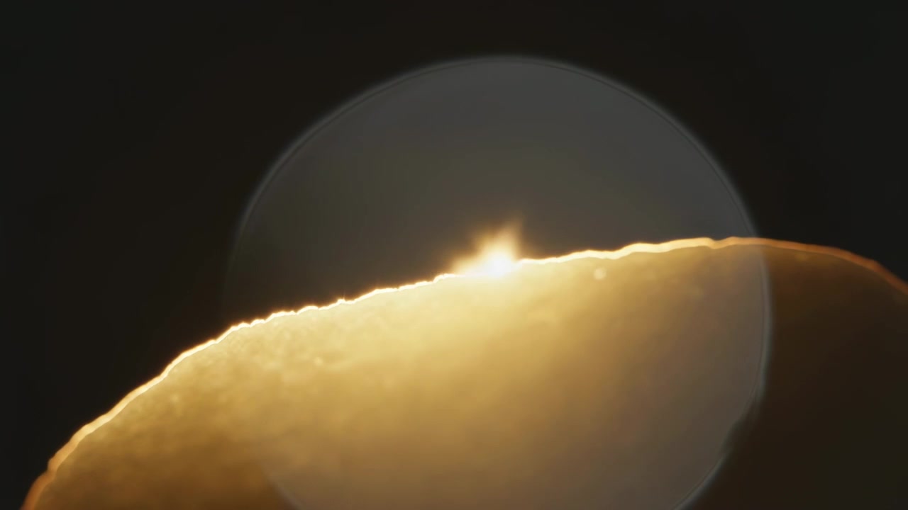 Focusing camera showing lit crescent shifting focus in night sky revealing ghost disk and bump