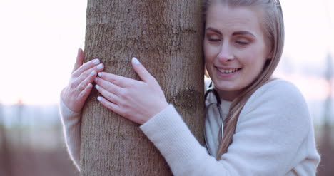 beautiful loving nature woman hugs tree in forest in autumn 4