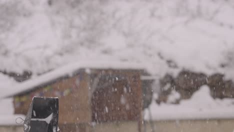 See-a-yellow-snowblower-in-slow-motion-clear-a-snowy-driveway