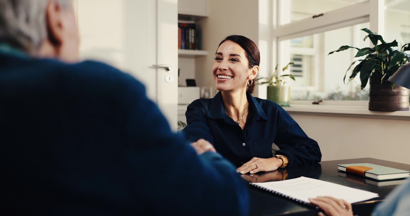 Professional Businesswoman Shaking Hands with Client in Office Meeting