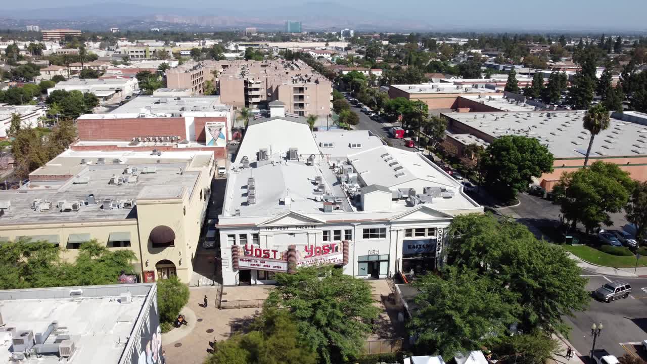 Cinematic aerial footage of the concert and events venue of Yost Theater in the downtown historic district of the California city of Santa Ana.