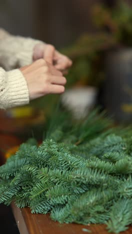 woman making a christmas wreath