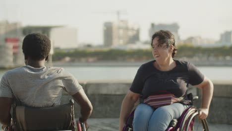 happy couple using wheelchairs dancing, spinning and giving five