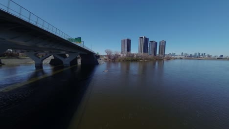 saint lawrence river with residential buildings under construction in nuns' island, montreal canada