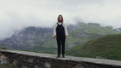 woman standing on a mountain wall