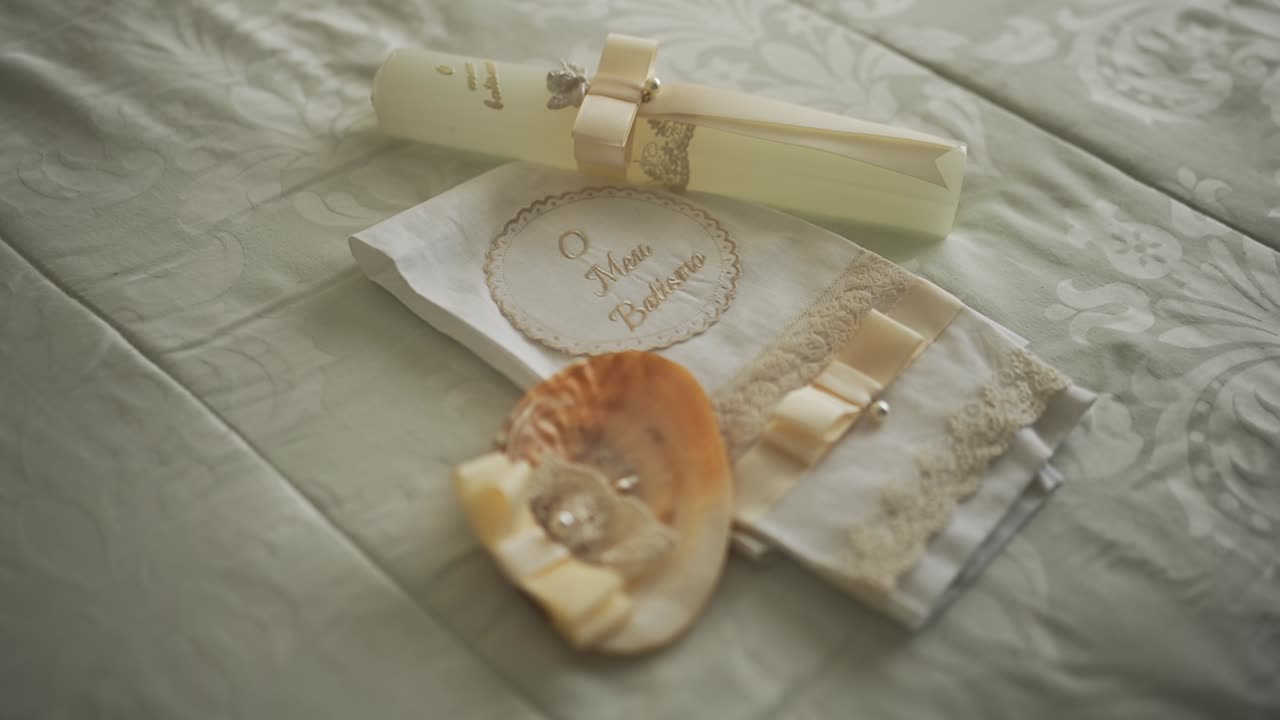Elegant baptism set with candle, lace cloth, and shell