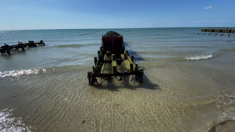 Wooden-stilts-for-harvesting-mussel-and-oyster-on-ocean-beach-coast,-clear-water