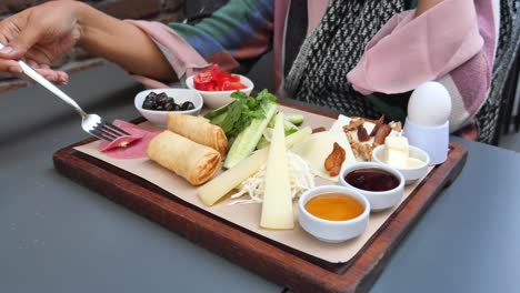 a delicious turkish breakfast with cheese, olives, cucumbers, tomatoes, honey, butter, and bread